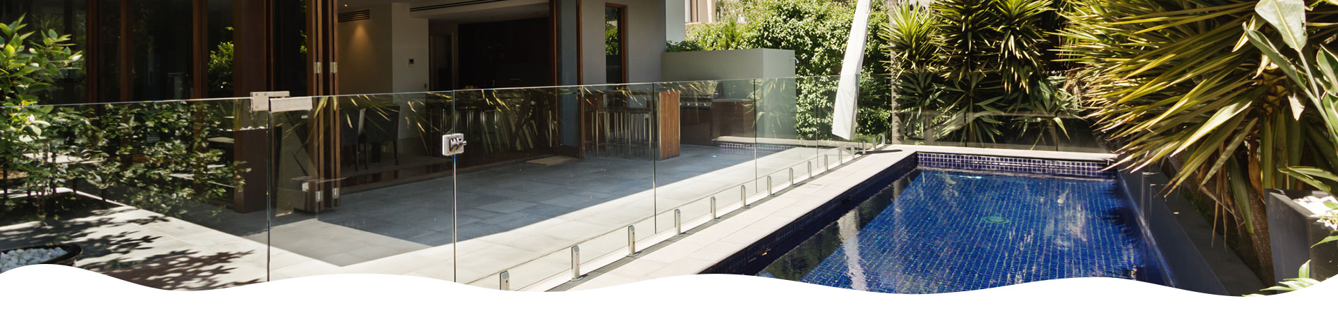 Glass pool barrier for pool in modern home